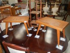2 teak table with carved tops and a cake stand