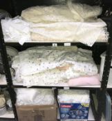 3 shelves of bedding & net curtains