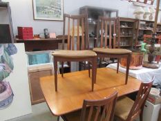 A teak table and 4 chairs