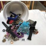 A mixed lot of costume jewellery and watches in a planter