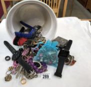 A mixed lot of costume jewellery and watches in a planter