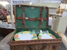A wicker picnic basket with contents