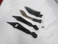 A small kukri and 2 wooden knives with carved head handles