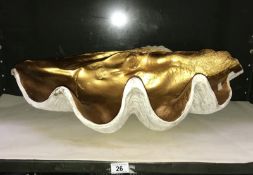 A large sculpted clam shell with gold painted interior