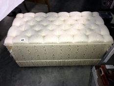 A fabric covered deep buttoned ottoman/blanket box