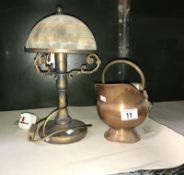 A vintage lamp and small copper coal scuttle