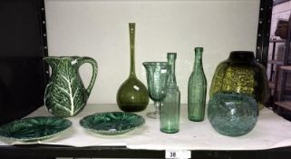 A collection of green glass items and green pottery items