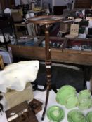 A dark wood stained tripod torchiere stand