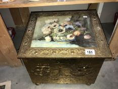 A brass coal box with floral picture lid