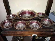 A 7 piece cut glass fruit set with ruby glass band & gold rim consisting of serving bowl & 6