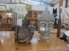 A Buddha head and an oriental figure