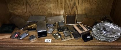 A collection of cigarette cases & lighters including James Bond themed lighter & a quantity of