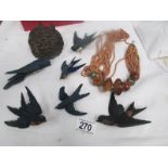 A quantity of carved wood birds and a necklace