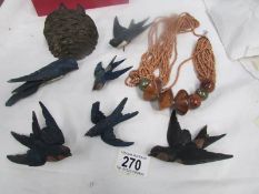 A quantity of carved wood birds and a necklace