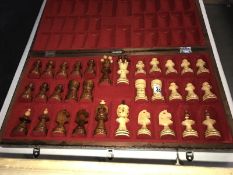 A carved chess set in chess board box