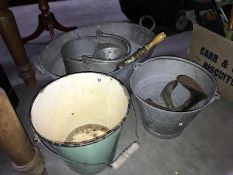 A small metal bathtub, metal buckets,