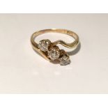 An 18ct 3 stone diamond cross over ring,