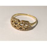 An 18ct yellow gold ring set oval diamond with diamond surround,