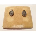 A pair of 2 tone gold oval diamond earrings