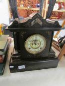 A Victorian black marble mantel clock