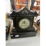 A Victorian black marble mantel clock