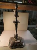 A silver plate candlestick with snuffer