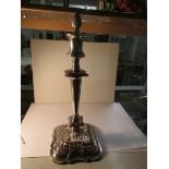 A silver plate candlestick with snuffer