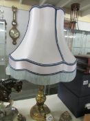 A gilded table lamp with shade