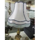 A gilded table lamp with shade