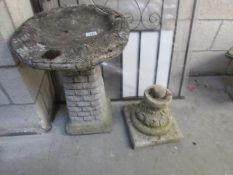 A bird bath and a spare pedestal.