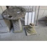 A bird bath and a spare pedestal.