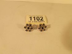 A pair of diamond and sapphire stud earrings