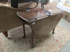 A mahogany pad foot drop leaf table.