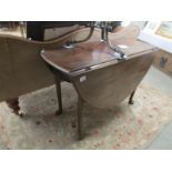 A mahogany pad foot drop leaf table.