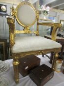 A gilded salon chair