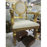 A gilded salon chair