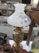 A brass oil lamp with shade