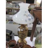 A brass oil lamp with shade