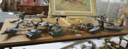 A quantity of unboxed die cast and plastic military aircraft, tanks and ships.