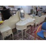 A French style headboard with attached bedsides, a matching cheval mirror, dressing table,