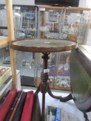 An oval wine table with leather inset top