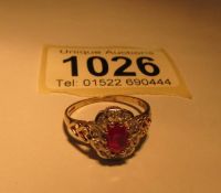 A yellow gold diamond and garnet ring,