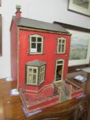 A late 19th/ early 20th century doll house and contents.