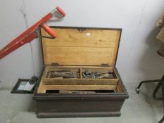 A pine tool chest containing old tools.