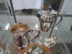 A silver plate coffee pot, jug and ladle.