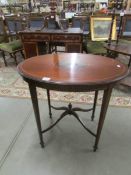 A oval Edwardian inlaid table.