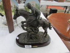 A horse and jockey figure on stand
