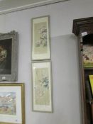 A pair of signed oriental framed and glazed bird/flower panels,