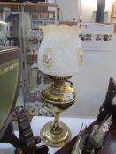 A brass oil lamp with shade