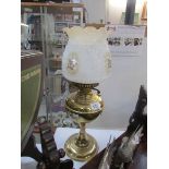 A brass oil lamp with shade